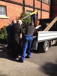 Loading the main frame onto a truck with some helping hands